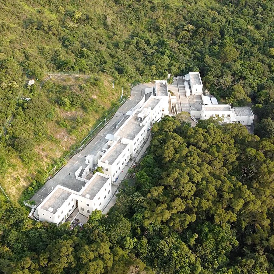 Aerial view of Dhamma Mutta on Hong Kong’s Lantau Island, embedded in a forest. 
